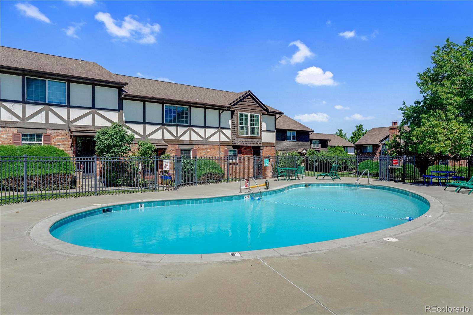 3855 South Monaco Street, Unit 203 Denver, CO 80237 - Photo 22 of 26 a view of a house with swimming pool and a yard