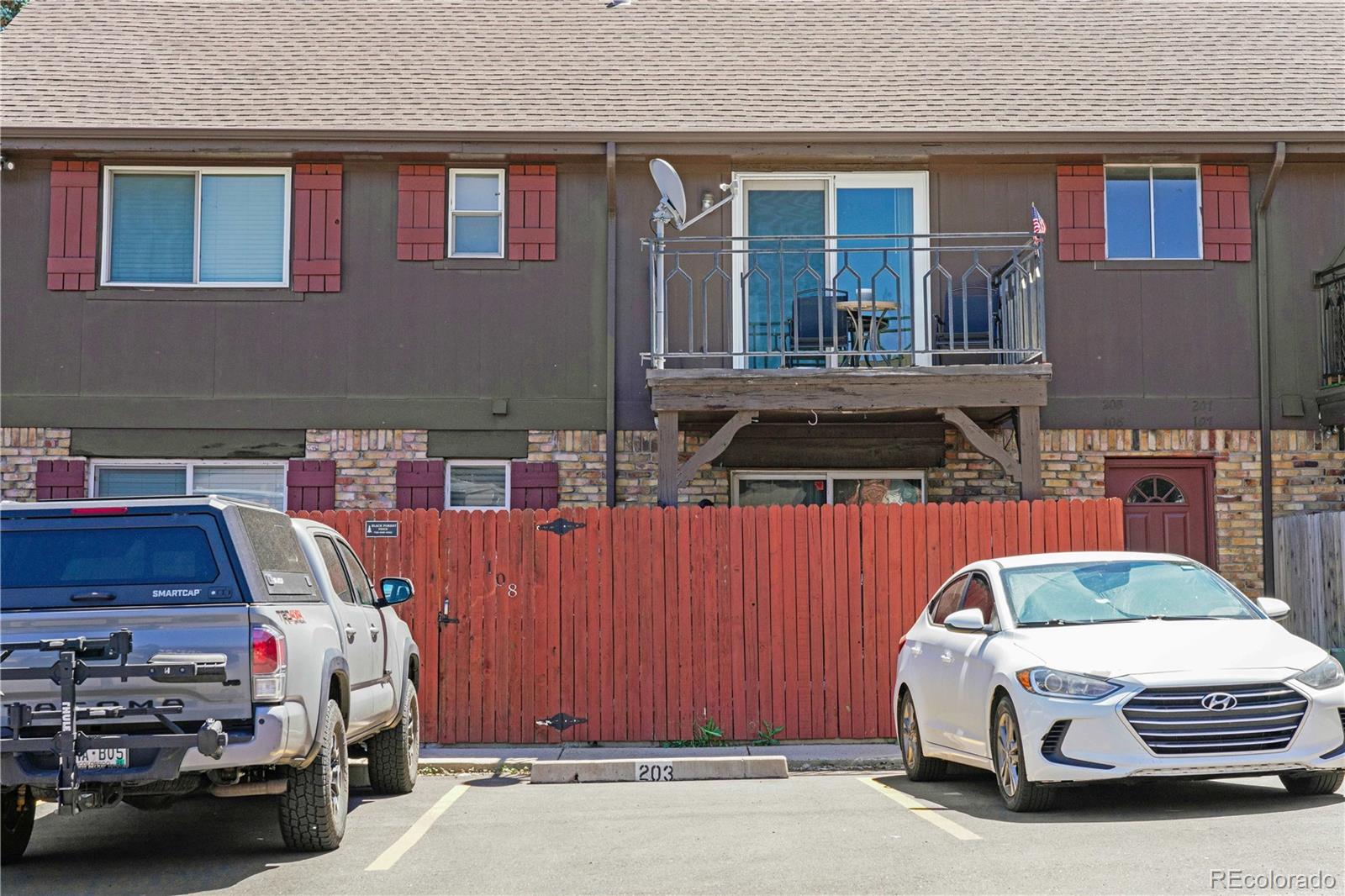 3855 South Monaco Street, Unit 203 Denver, CO 80237 - Photo 25 of 26 a car parked in front of a building