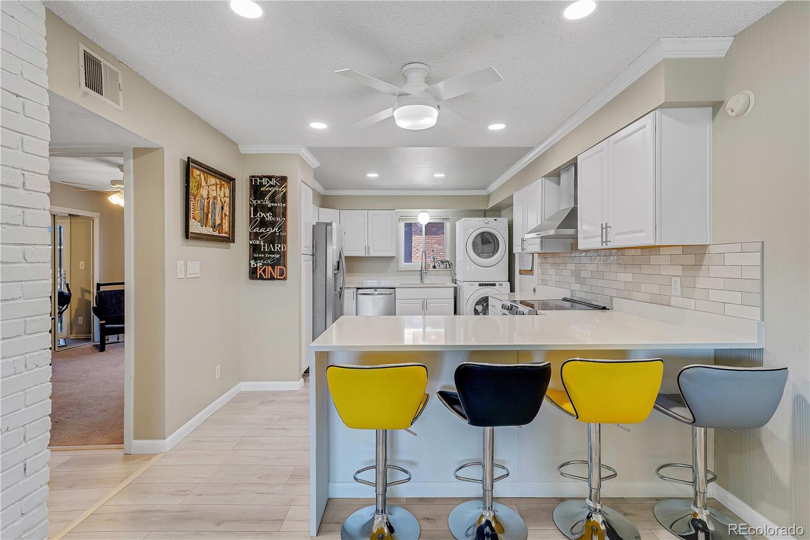 3855 South Monaco Street, Unit 203 Denver, CO 80237 - Photo 5 of 26 a kitchen with a dining table and chairs