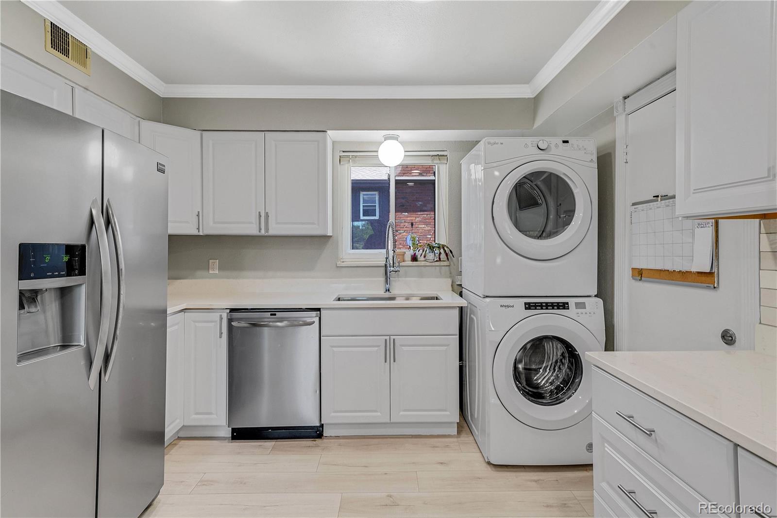 3855 South Monaco Street, Unit 203 Denver, CO 80237 - Photo 8 of 26 a kitchen with a washer and dryer