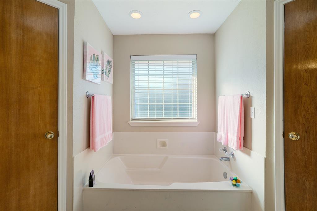 925 Medalist Street Paris, TX 75460 - Photo 16 of 24 a white bath tub sitting next to a window