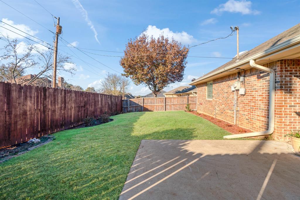 925 Medalist Street Paris, TX 75460 - Photo 23 of 24 a view of a backyard with wooden fence