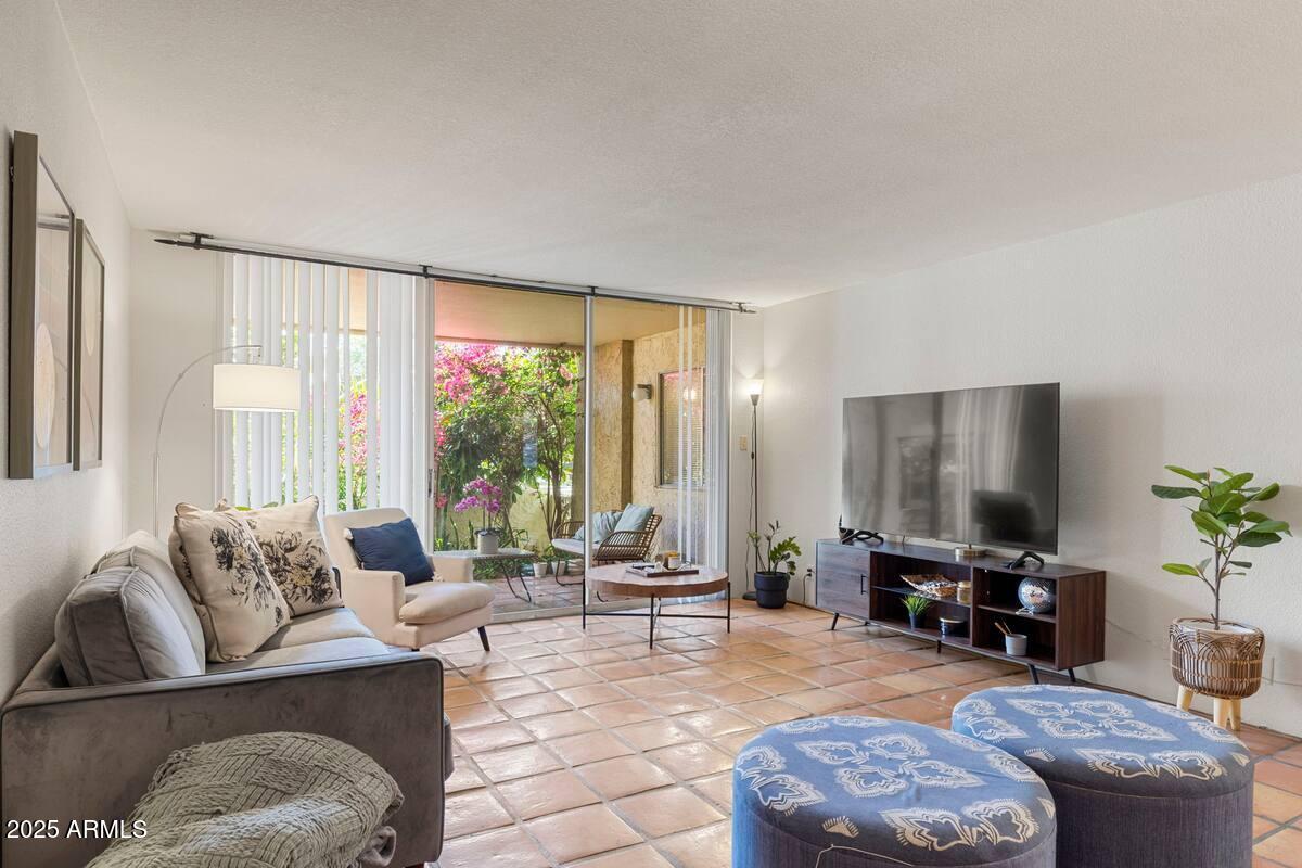 7625 East Camelback Road, Unit B151 Scottsdale, AZ 85251 - Photo 1 of 16 a living room with furniture and large windows