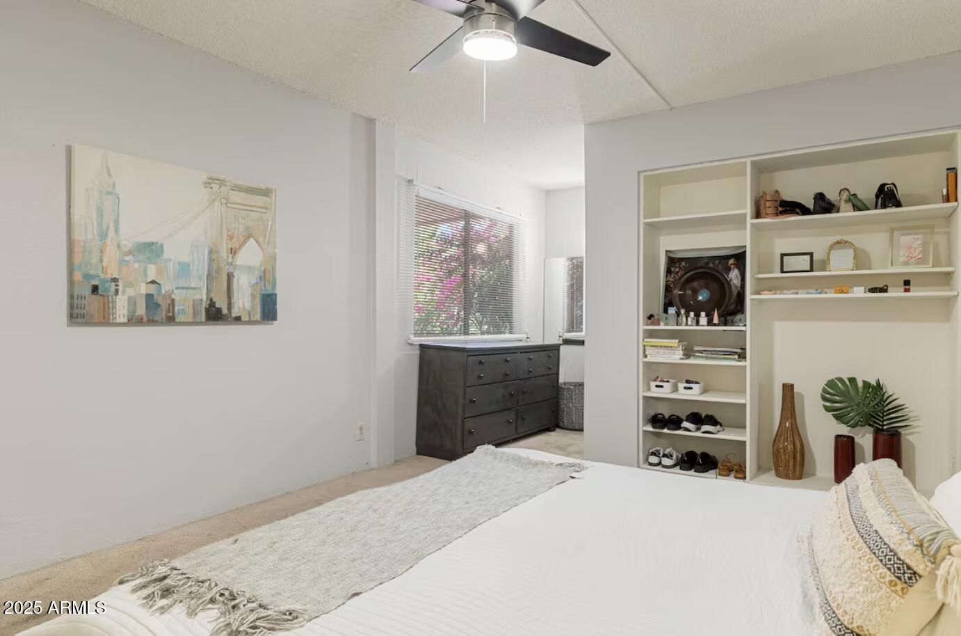 7625 East Camelback Road, Unit B151 Scottsdale, AZ 85251 - Photo 11 of 16 a bedroom with a bed and a chandelier