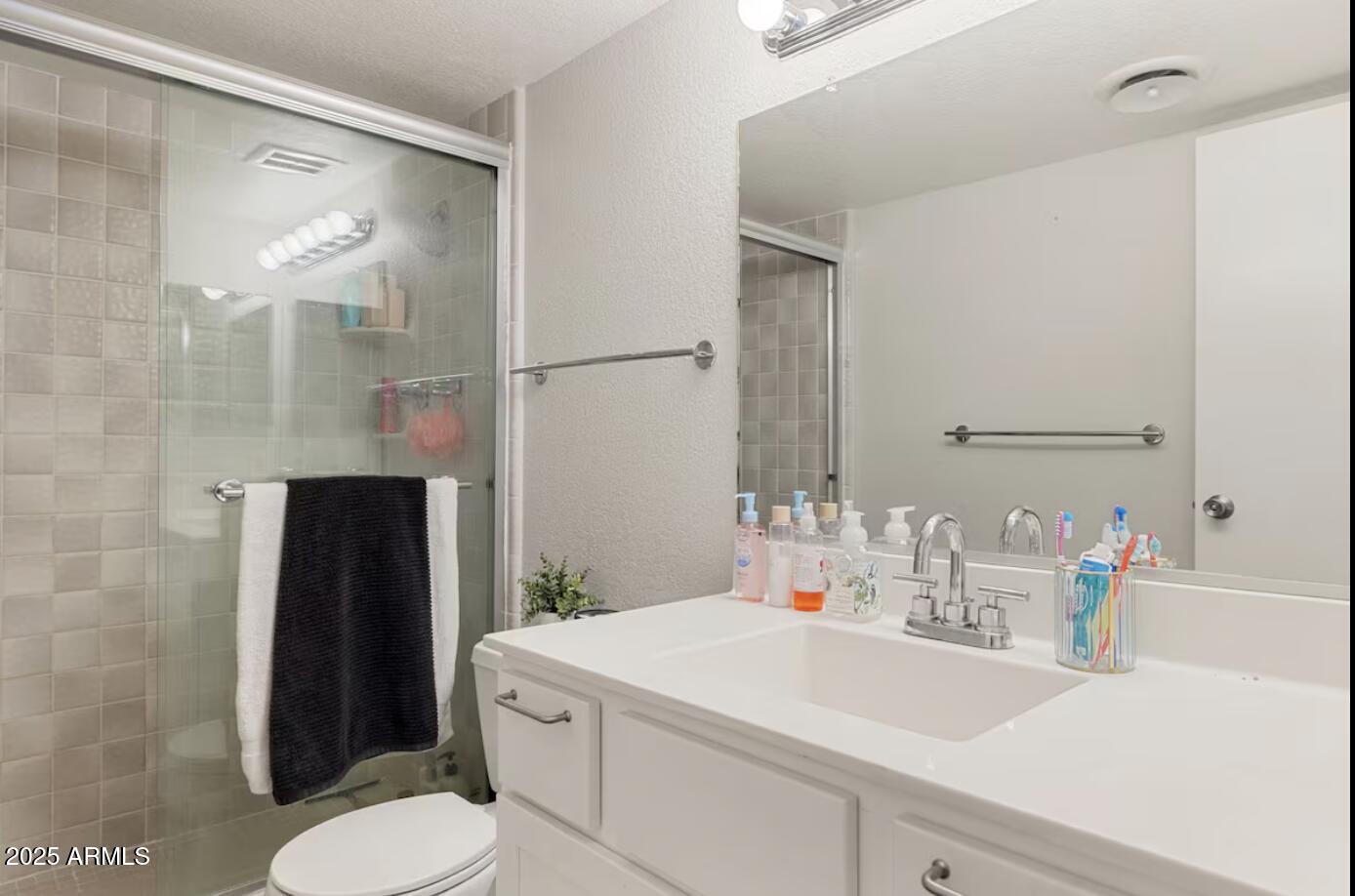 7625 East Camelback Road, Unit B151 Scottsdale, AZ 85251 - Photo 13 of 16 a bathroom with a sink toilet and shower