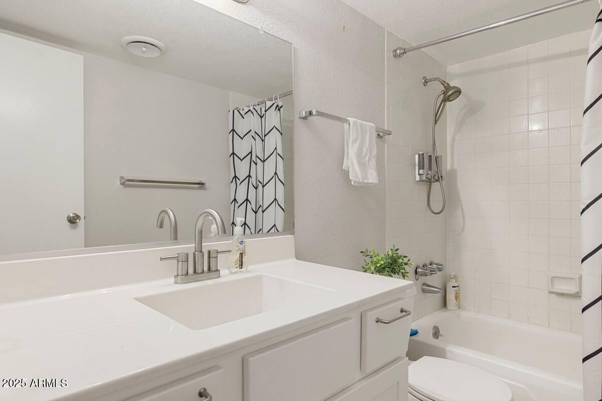 7625 East Camelback Road, Unit B151 Scottsdale, AZ 85251 - Photo 16 of 16 a bathroom with a sink vanity granite toilet tub and shower