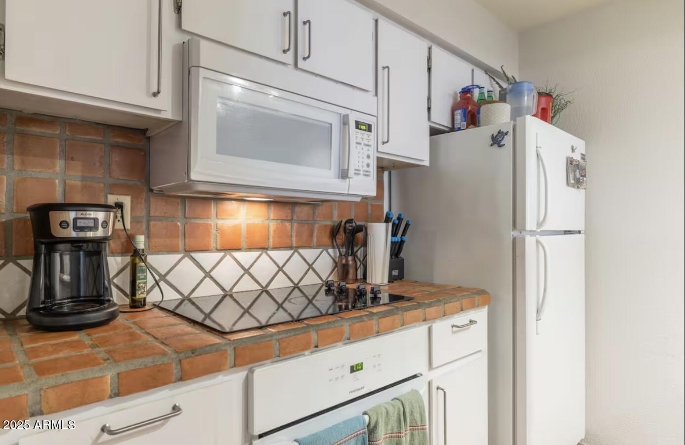 7625 East Camelback Road, Unit B151 Scottsdale, AZ 85251 - Photo 8 of 16 a kitchen with stainless steel appliances granite countertop a refrigerator and a stove top oven
