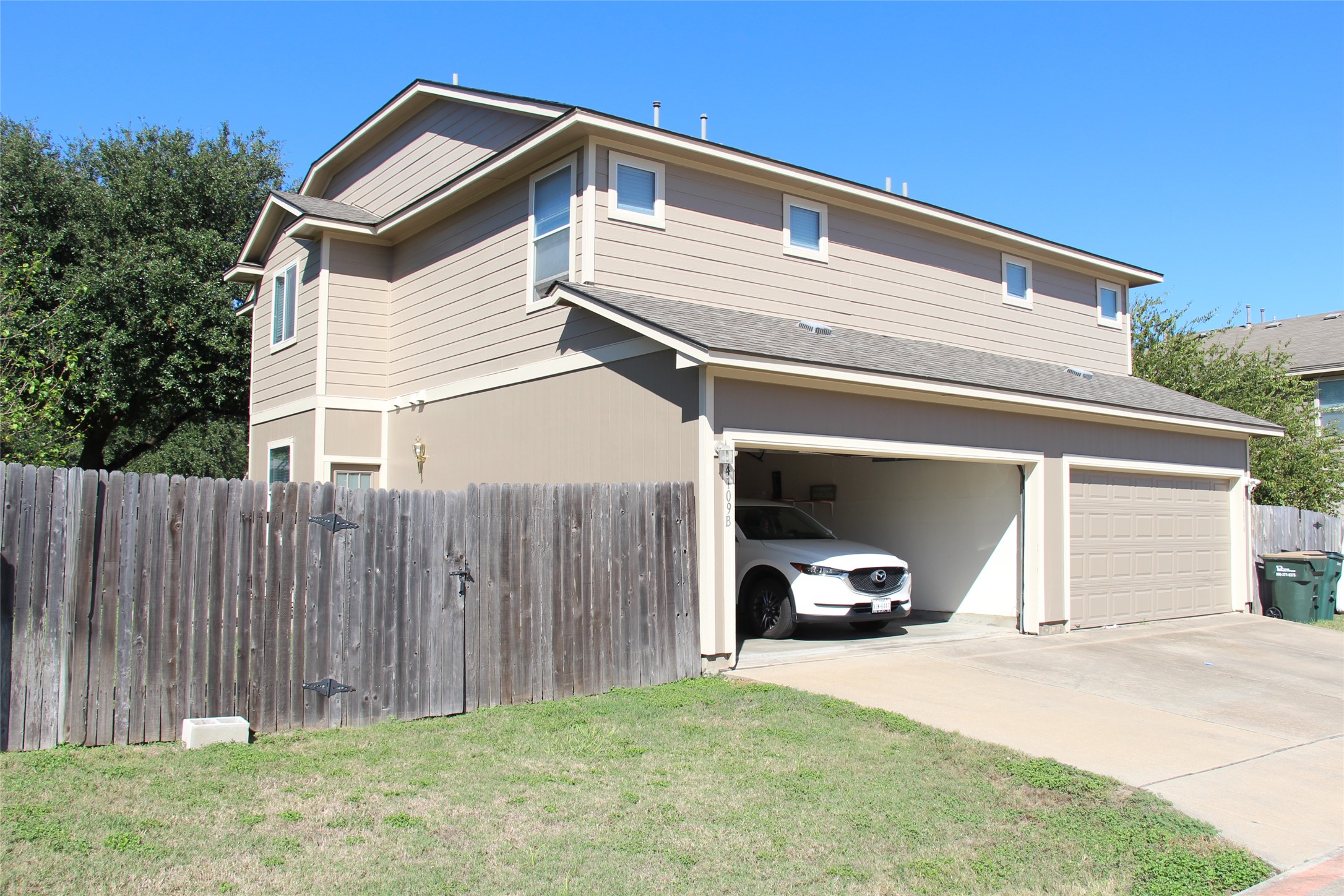 14109 Harris Ridge Boulevard, Unit A & B Pflugerville, TX 78660 - Photo 6 of 22 Multi-level modern construction features a spacious multi-car garage and a substantial wood privacy fence.
