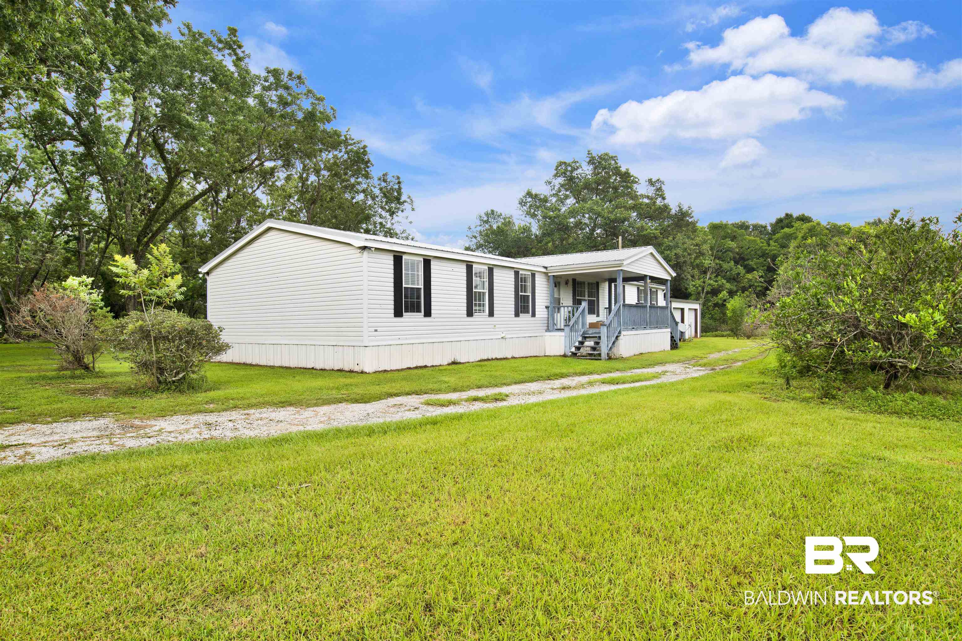 25700 County Road 71 Robertsdale, AL 36567 - Photo 25 of 40 Manufactured / mobile home featuring covered porch and a front lawn
