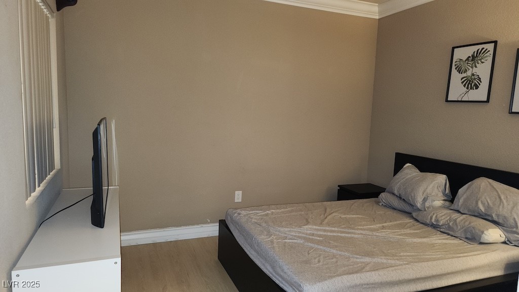270 East Flamingo Road, Unit 133 Las Vegas, NV 89169 - Photo 4 of 13 Bedroom featuring wood finished floors and crown molding