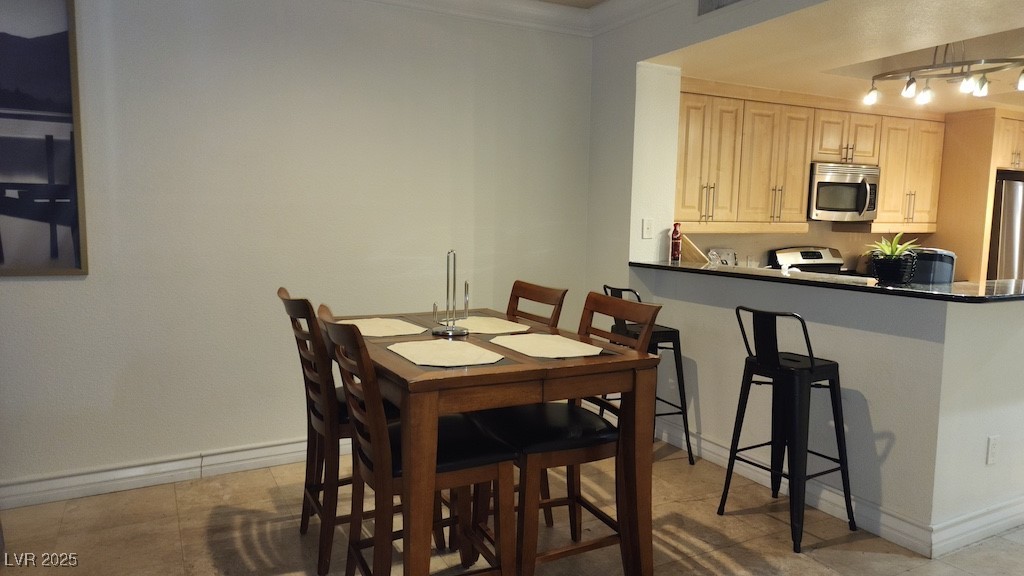 270 East Flamingo Road, Unit 133 Las Vegas, NV 89169 - Photo 6 of 13 Dining space with track lighting and ornamental molding