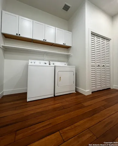 a view of kitchen with granite countertop cabinets and wooden floor