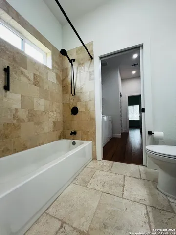 a bathroom with a bathtub and a shower
