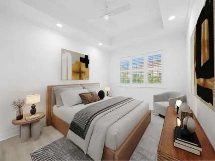 a bedroom with a bed and a large window