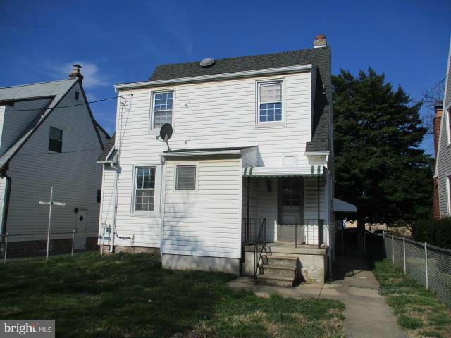 39 Township Road Baltimore, MD 21222 - Photo 2 of 24 a front view of a house with a garden