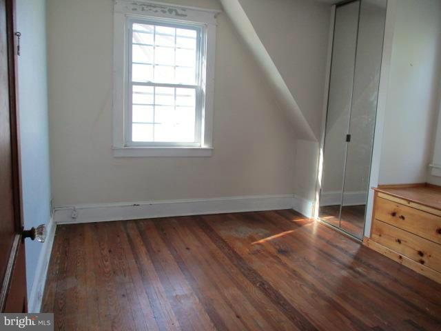 39 Township Road Baltimore, MD 21222 - Photo 12 of 24 an empty room with wooden floor and windows