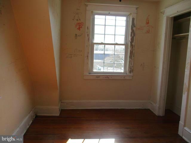 39 Township Road Baltimore, MD 21222 - Photo 14 of 24 an empty room with wooden floor and windows