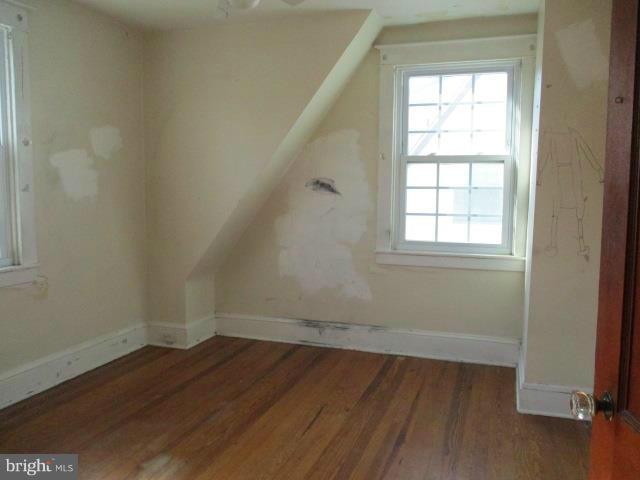 39 Township Road Baltimore, MD 21222 - Photo 16 of 24 an empty room with wooden floor and windows