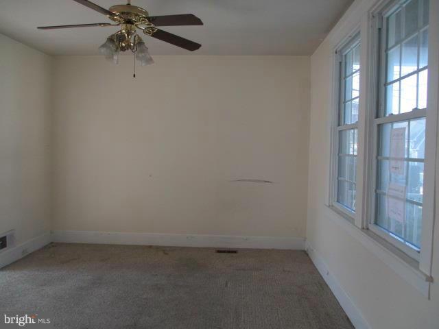 39 Township Road Baltimore, MD 21222 - Photo 4 of 24 an empty room with windows and fan