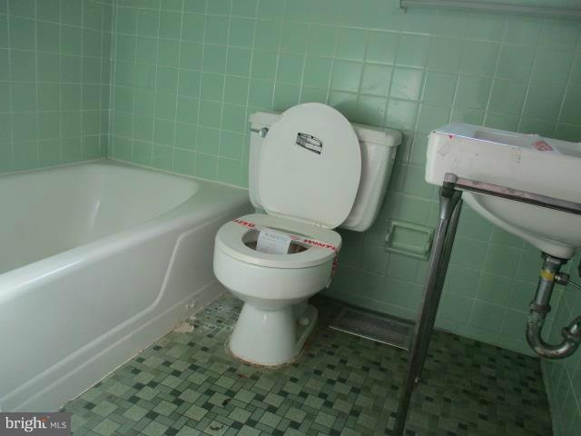 39 Township Road Baltimore, MD 21222 - Photo 9 of 24 a bathroom with a toilet and a tub