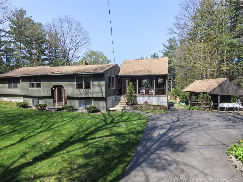 a front view of a house with yard patio and green space