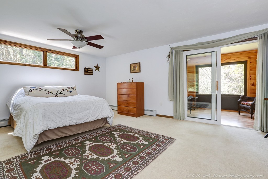 65 Colony Road Phillipston, MA 01331 - Photo 17 of 26 a bedroom with a bed and glass door