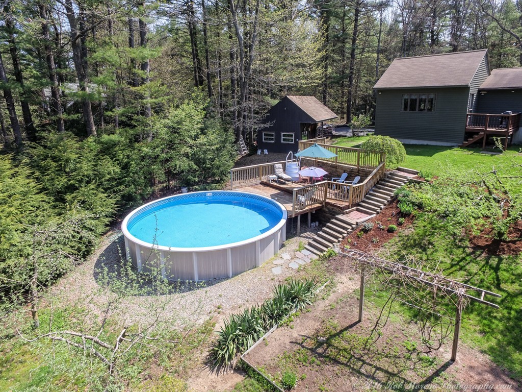 65 Colony Road Phillipston, MA 01331 - Photo 26 of 26 a view of a backyard with table and chairs potted plants and large tree
