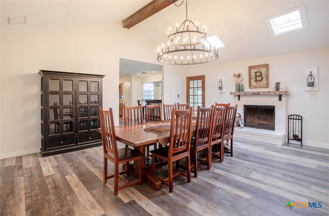 188 Cavalry Road Victoria, TX 77905 - Photo 11 of 30 a view of a dining room with furniture wooden floor and chandelier
