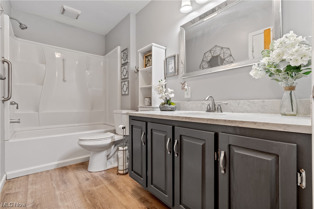 120 Lester Road New Franklin, OH 44319 - Photo 9 of 24 Full bathroom with vanity, shower / washtub combination, mirror, and light hardwood floors