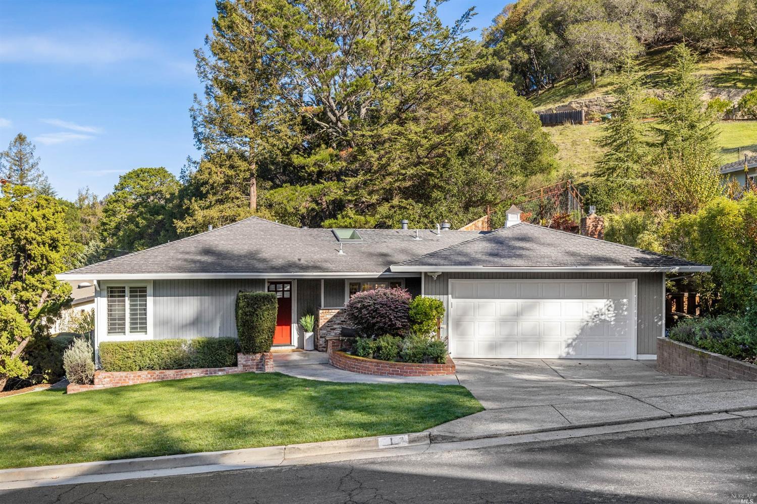 1 Edgehill Way San Rafael, CA 94903 - Photo 1 of 1 a front view of a house with a garden and trees
