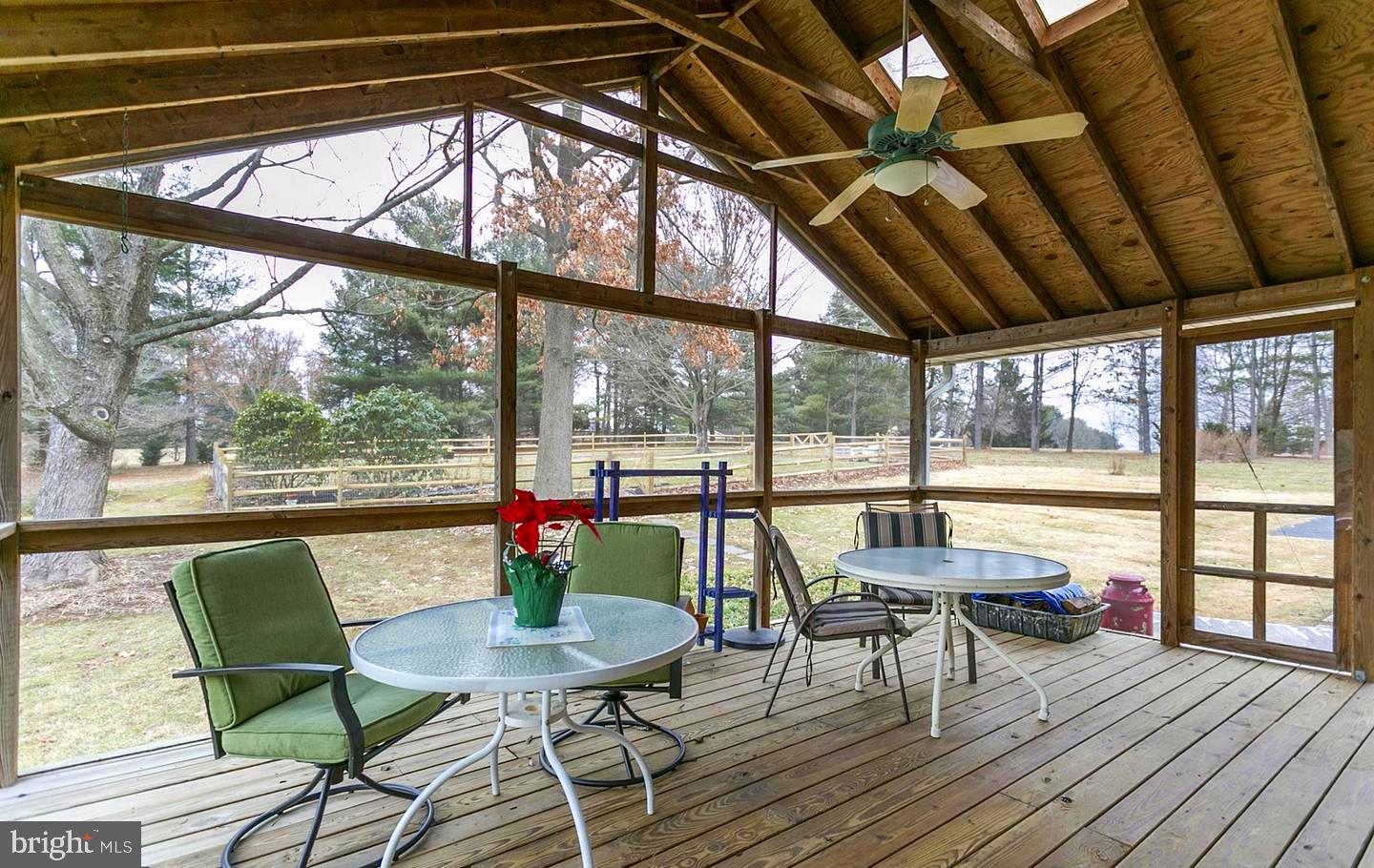 17208 Hunter Green Road Upperco, MD 21155 - Photo 4 of 7 a living room with large windows and wooden floor