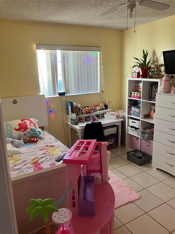 7960 Northwest 174th Street Hialeah, FL 33015 - Photo 7 of 20 a bedroom with a bed and a table in it