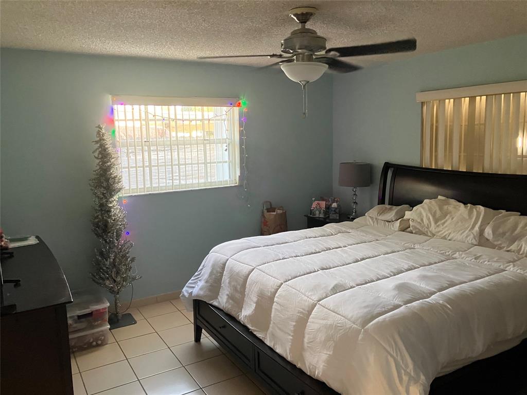 7960 Northwest 174th Street Hialeah, FL 33015 - Photo 8 of 20 a bedroom with a bed and a window