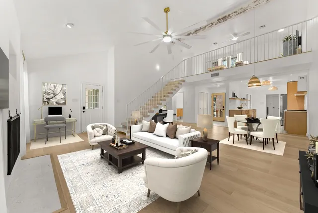 a living room with furniture kitchen view and a chandelier