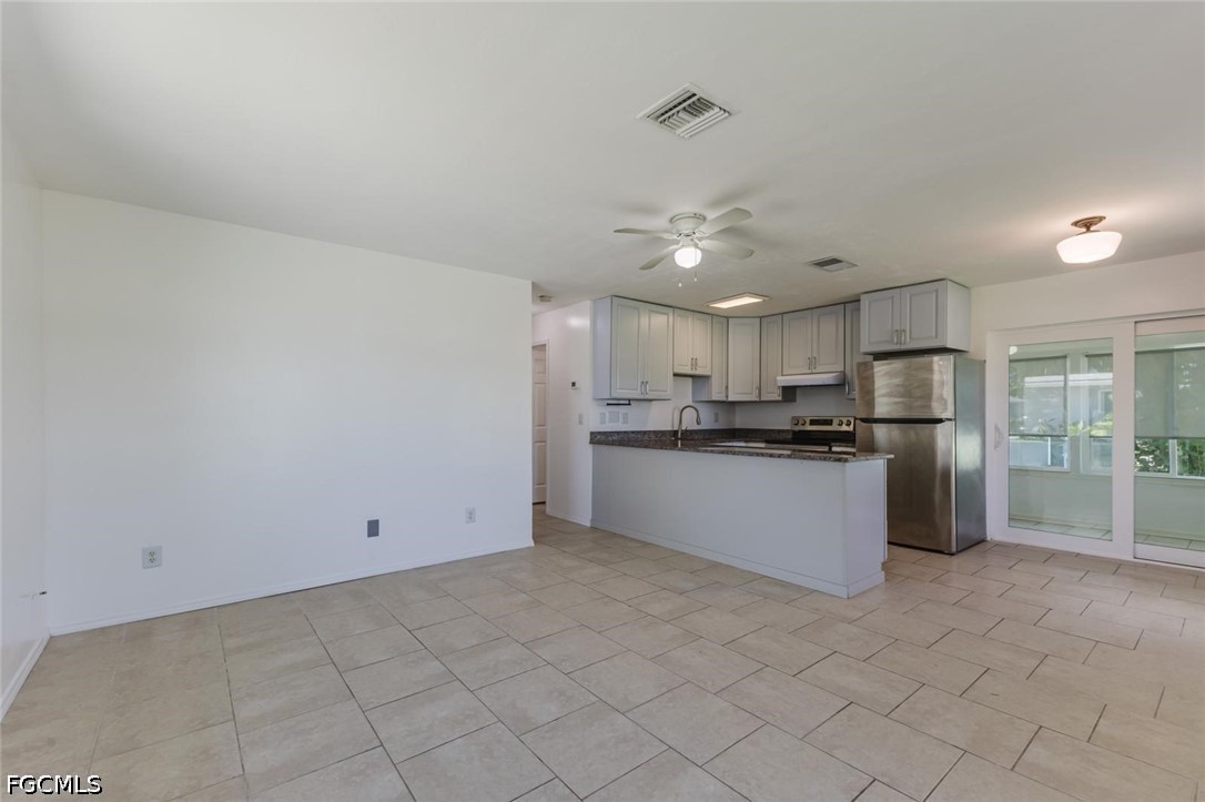 16595 Davis Road Fort Myers, FL 33908 - Photo 6 of 31 a large kitchen with cabinets and stainless steel appliances