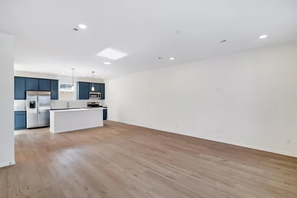 a view of kitchen with microwave and cabinets