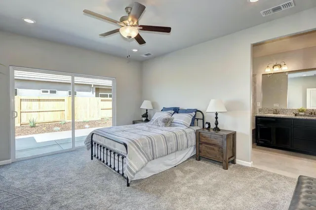 a spacious bedroom with a bed and a chandelier