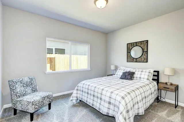 a bedroom with a bed and chandelier