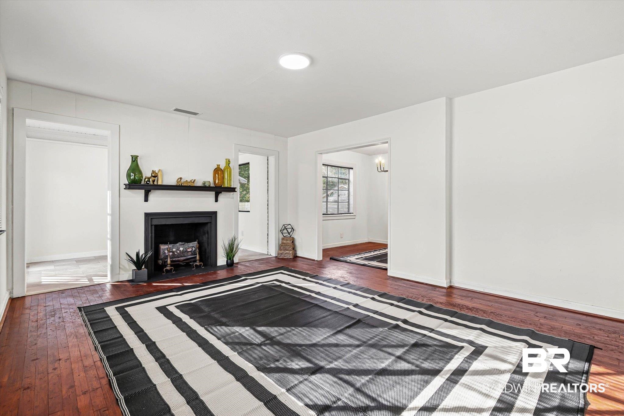 2806 Exter Drive Mobile, AL 36606 - Photo 2 of 24 Unfurnished living room with dark wood-style floors and a fireplace with flush hearth