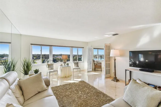 a living room with furniture a front door and a window