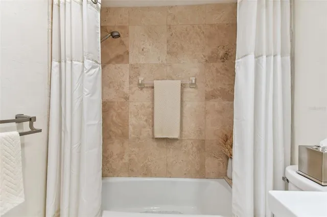 a view of a backyard with a garden and entertaining space