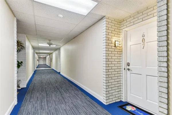 a dining hall with stainless steel appliances kitchen island granite countertop a table and chairs in it