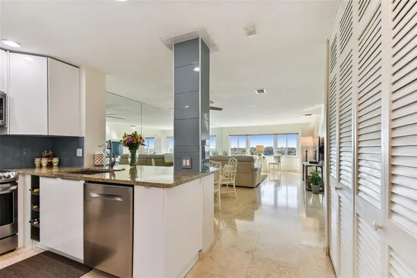 a kitchen with stainless steel appliances granite countertop a sink and cabinets