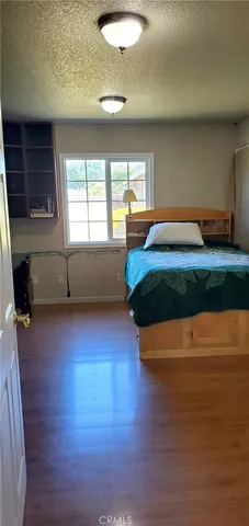 a spacious bedroom with a bed and a large window