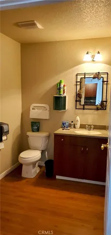 a bathroom with a toilet mirror and vanity