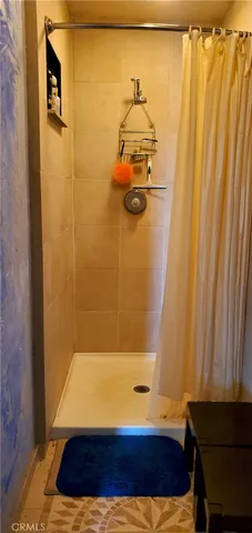 a bathroom with a bathtub and shower