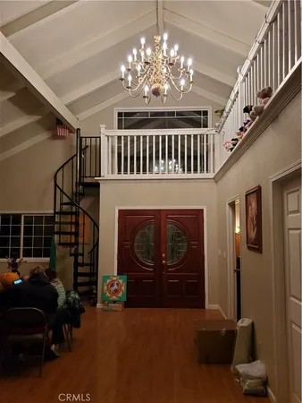 a living room with furniture a chandelier and a fireplace
