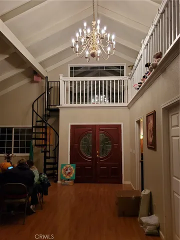 a living room with furniture a chandelier and a fireplace