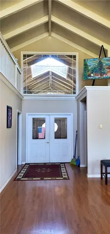 a view of a livingroom with wooden floor and stairs
