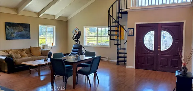 a living room with furniture a window and wooden floor
